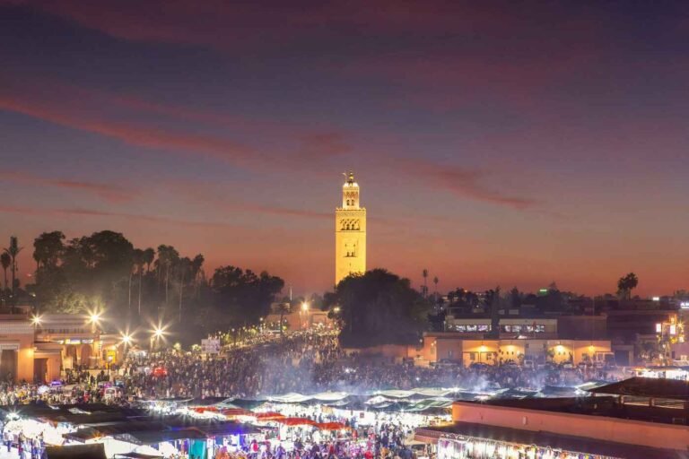 Koutoubia Mosque standing tall against a glowing sunset in Marrakech, highlighting the city’s vibrant sightseeing spots